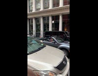 Guy in convertible car sings karaoke 