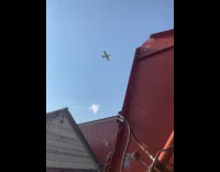 Crop duster plane flyby above the farm