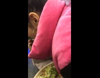 girl pink sweaters eats food with cardboard