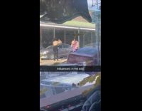 Woman in brown coat poses in the middle of the street
