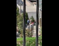 Guy bounces ball into net while standing on tall pole 