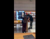 Man inside apple store with pet birds 