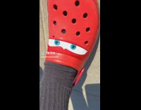 Man flexing his lightning mcqueen crocs 