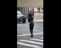 Long haired man red shoes dance on crosswalk
