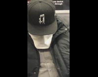 Man asleep in train hat with music note