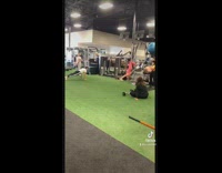 Woman uses TRX bar at gym to swing