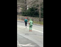 Man leprechaun costume jog kick ball park