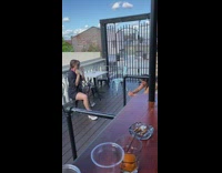 Brunette Lady Poses with Legs Apart on Chair 