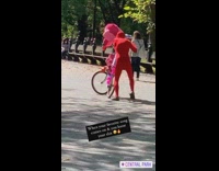 Red bodysuit guy gets off bicycle dances