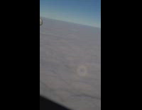 Plane fly over clouds shadow inside rainbow