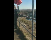 Couple hugged with heart balloons on the fence