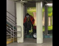 Shirtless guy sits on railing does crunches 