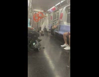Guy interlocks four orange rings hoops subway 