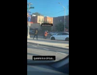 Man juggle pins in front of cars street