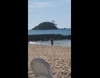 woman in jumper jumping for beach picture