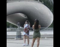 White shirt brown backpack girl metal sculpture