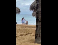 Couple takes a selfie on the beach shore