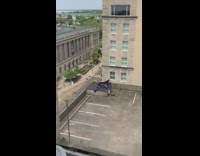 Woman violet dress wind photo shoot parking lot rooftop