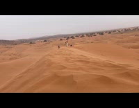 Woman headstand leg poses on sand dunes