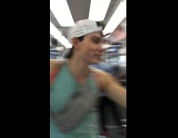 Man blue shirt hits glass screen window with drumstick on metro train