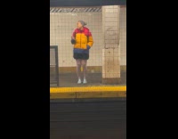 Woman play phone music dance at subway