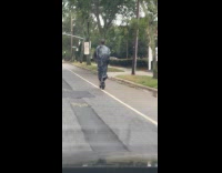 Man wear black plastic bag ride electric scooter