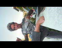 Guy puts foot on wall sprays disinfectant 