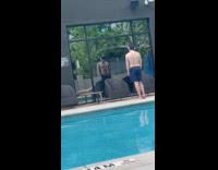 Man sticks phone on window near pool