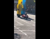 Dog on toy car with hoomans as tube man