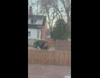 Woman red top pregnancy photo shoot backyard