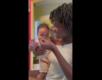 Baby laughing as mom blows on food