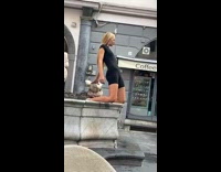 Woman in black outfit kneels in the fountain