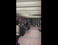 Guy plays music on cello in subway station