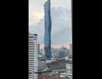 Woman showing how huge mardeka tower is