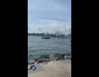 Black shorts guy swims around river water