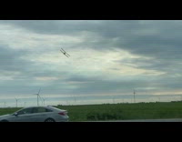 Duster plane flies over the filmers car