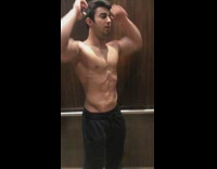 Shirtless guy elevator flex black pants 