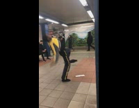 Guy does drag dance in subway station, wig flies off