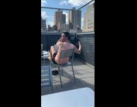 Pink shirt guy balcony selfie chain fence 