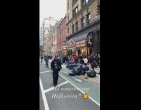 Long line of people wait to get into halloween store