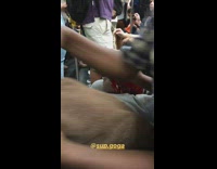 Woman ties red floral head scarf on mannequin head on subway train