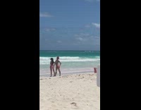 Girls pose on the beach 