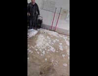 Men throws out block of ice off truck