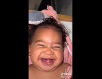 Mom plays with babys lips while baby laughs