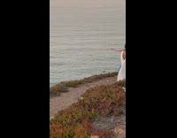Woman in blue dress poses with bubbles