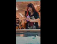 Woman made bagpipe from latex glove and straw