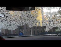 Ice flakes formed on car windshield glass