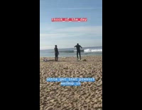 Black wetsuit guy warmup surf beach jumps 