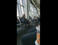 Girl Dances at Airport Next to Window 