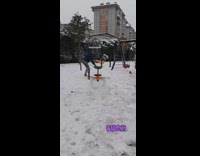 Guy removes snow from seesaw 